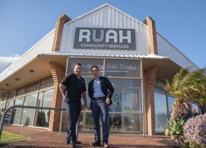 Two men standing outside a Ruah office.